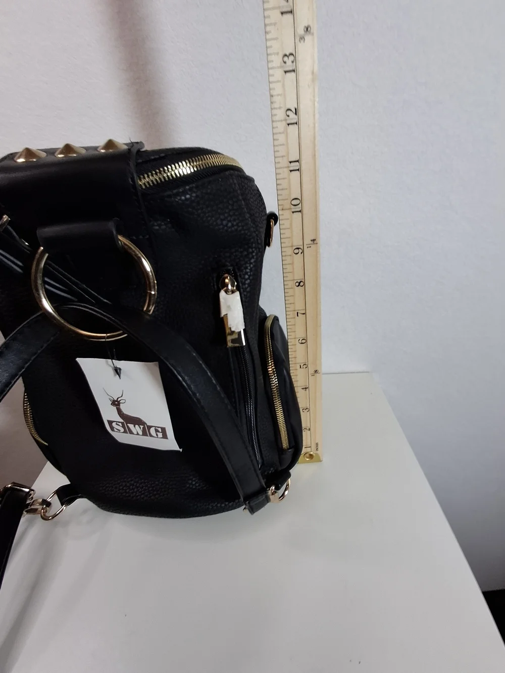 SWG Black Pebbled Sling Barrel Backpack with Gold Accents